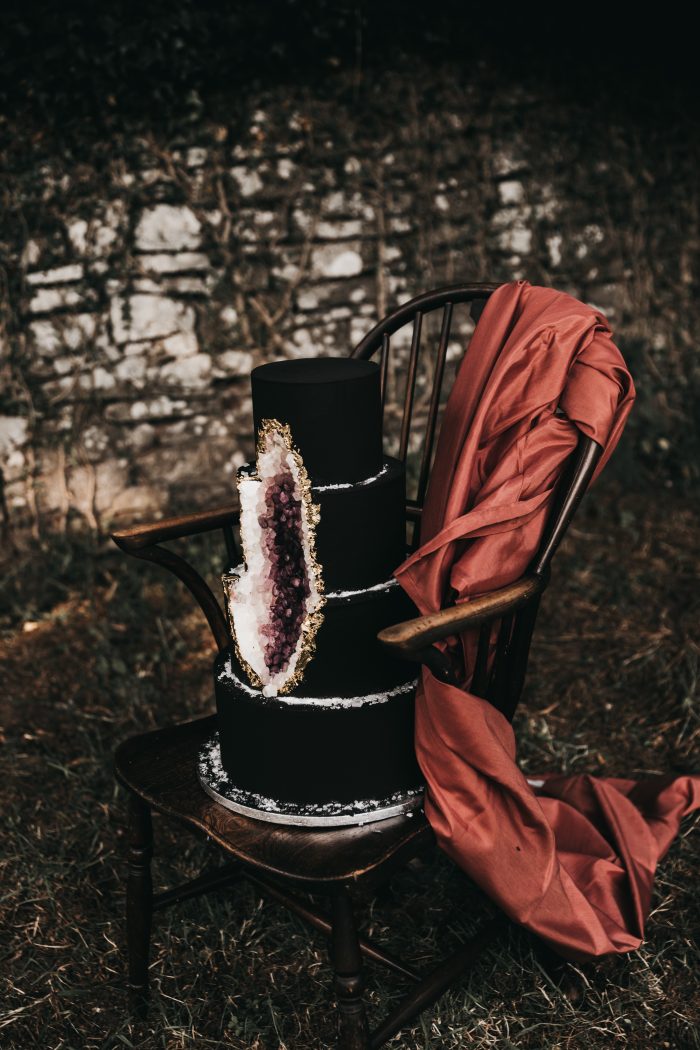 Black and Purple Geode Wedding Cake on Chair for Halloween