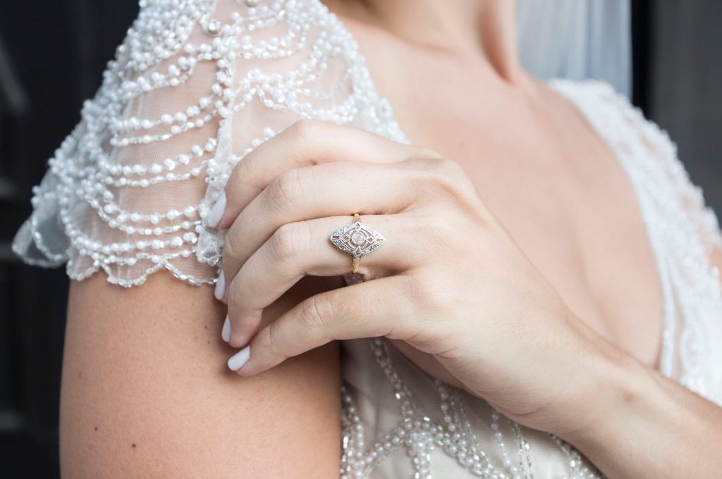Bride Wearing Vintage Wedding Dress by Maggie Sottero and Showing Engagement Ring on Her Hand