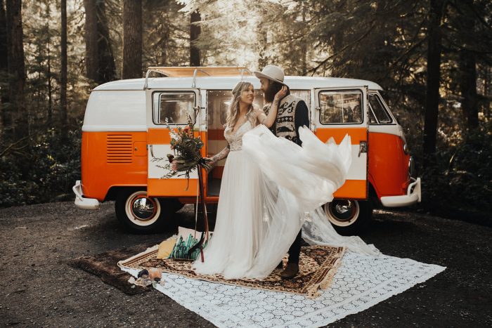 Groom with Bride Wearing Boho Wedding Gown Called Charlene by Maggie Sottero in Front of Orange Camper Van