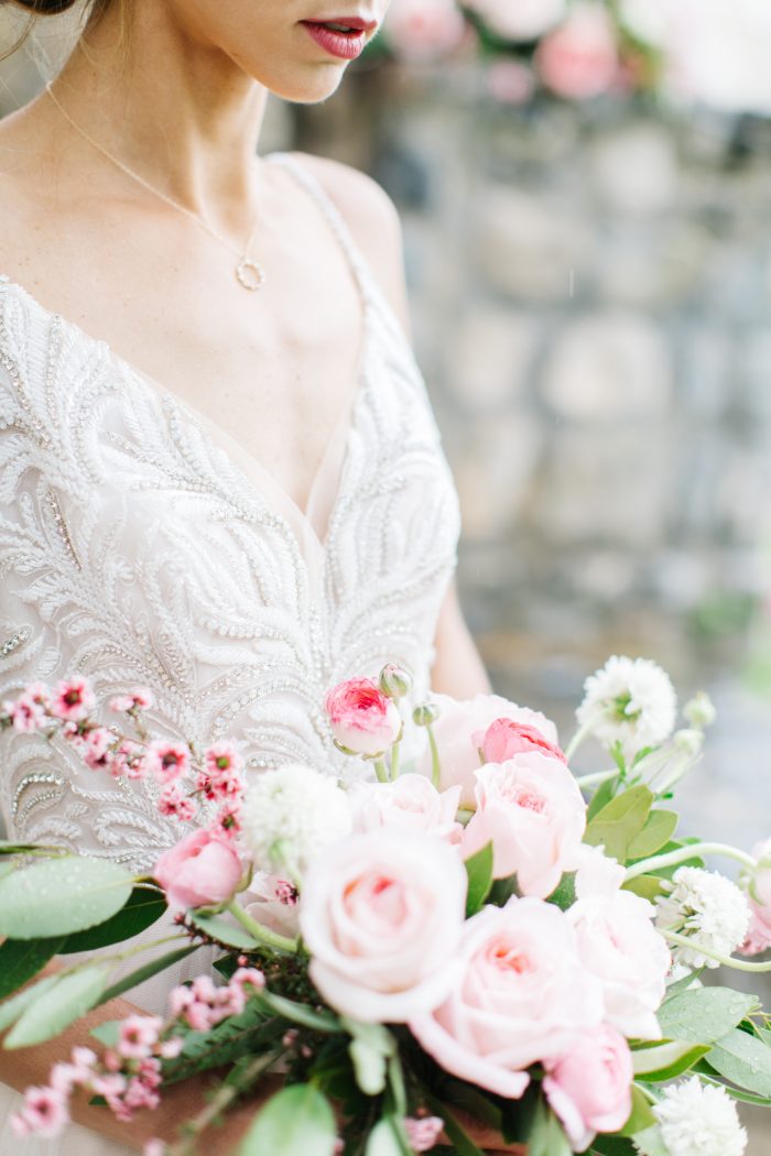 Pink flowers and Bride wearing Charlotte Wedding Dress by Maggie Sottero