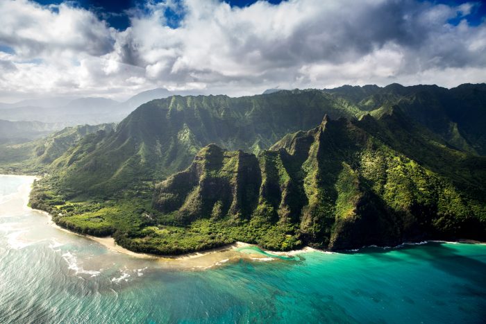 Aerial View of Gorgeous Beach and Vibrant Green Cliffs on Kauai, Hawaii