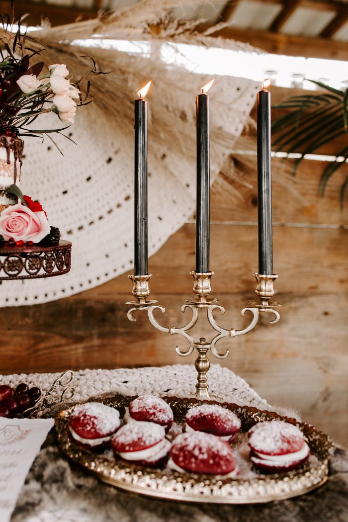 Vintage Candles on Table with Red Velvet Cookies with Cream Filled Middle for Fall Wedding Reception