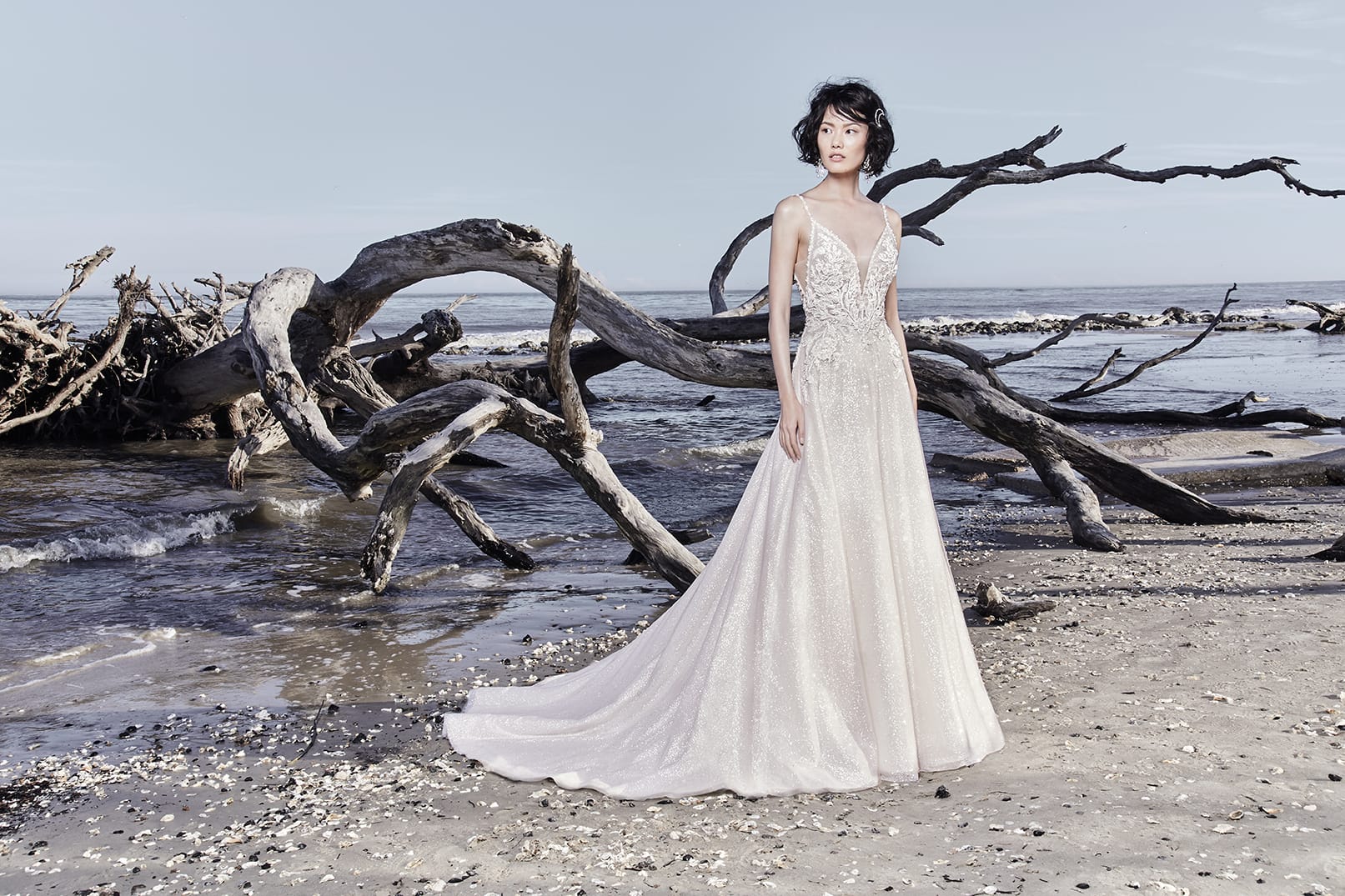 A photo of a model wearing an elegant sparkly wedding dress by Sottero and Midgley.