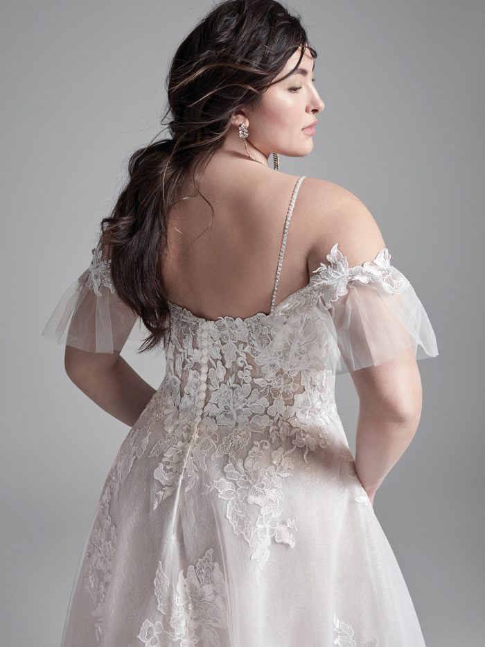 Curvy Model Wearing Plus Size Cold Shoulder A-line Wedding Dress Called Houston by Sottero and Midgley
