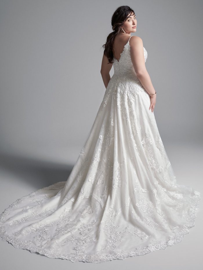Plus Size Model Wearing Plus Size Lace A-line Wedding Gown Called Lancaster by Sottero and Midgley