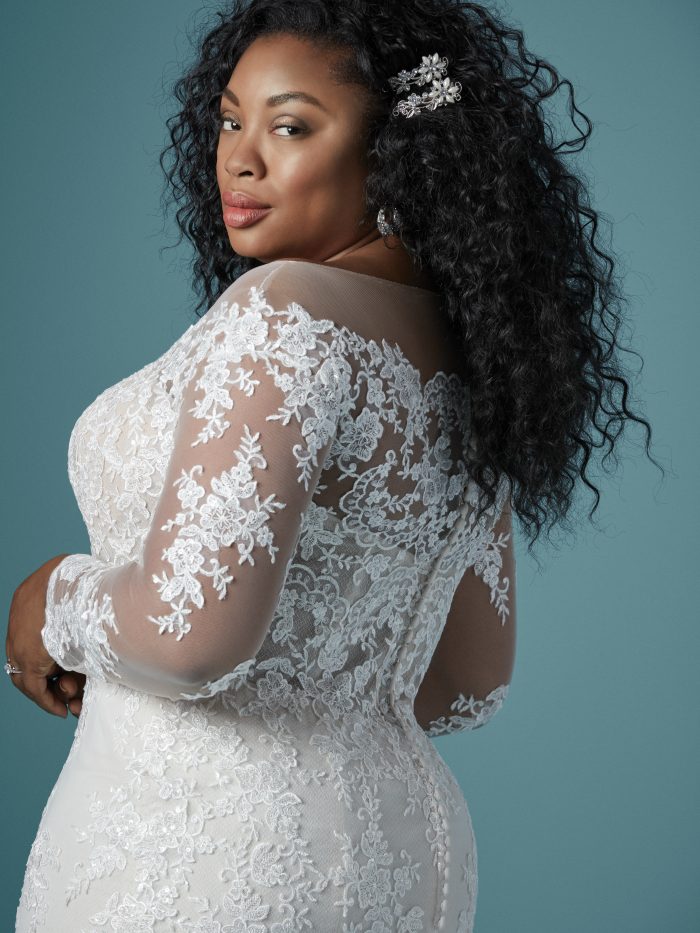 Curvy Black Model Wearing Plus Size Off the Shoulder Lace Wedding Gown Called Chevelle Lynette by Maggie Sottero