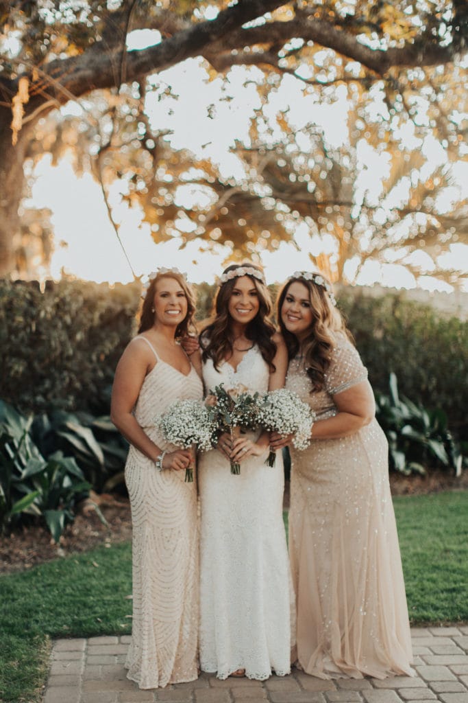 Bride Wearing Boho Wedding Dress by Rebecca Ingram Standing with Her Two Sisters and Bridesmaids at Real Wedding