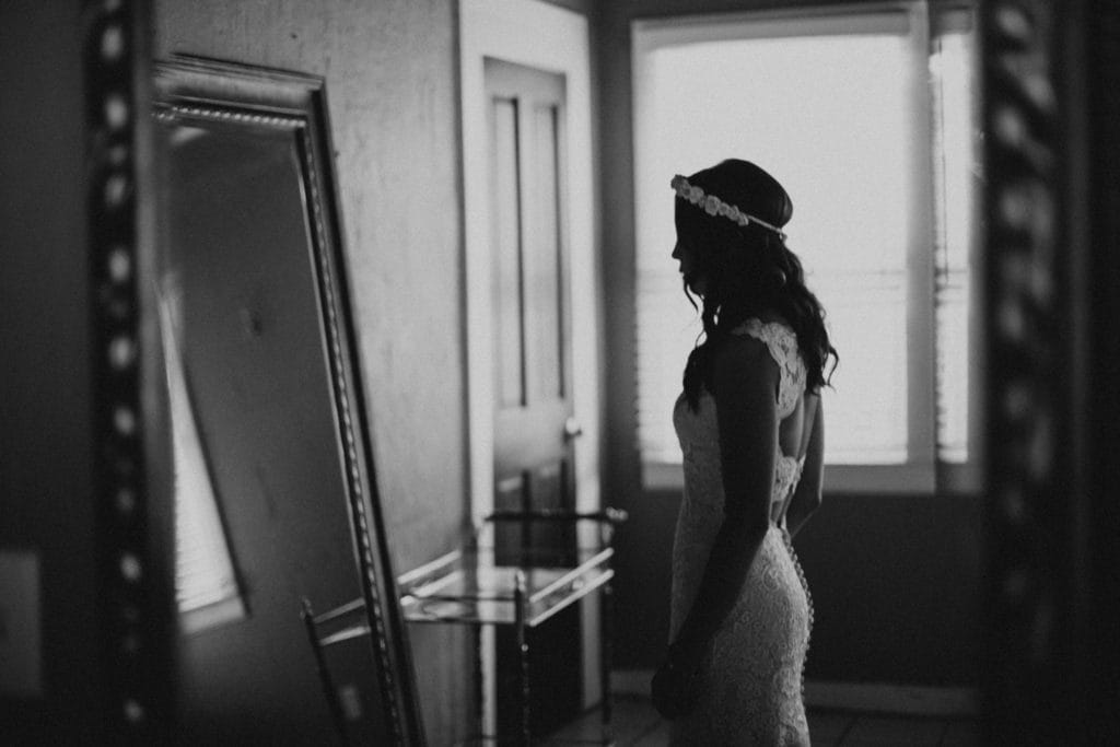 Black and White Image of Bride Looking in Mirror on Wedding Day