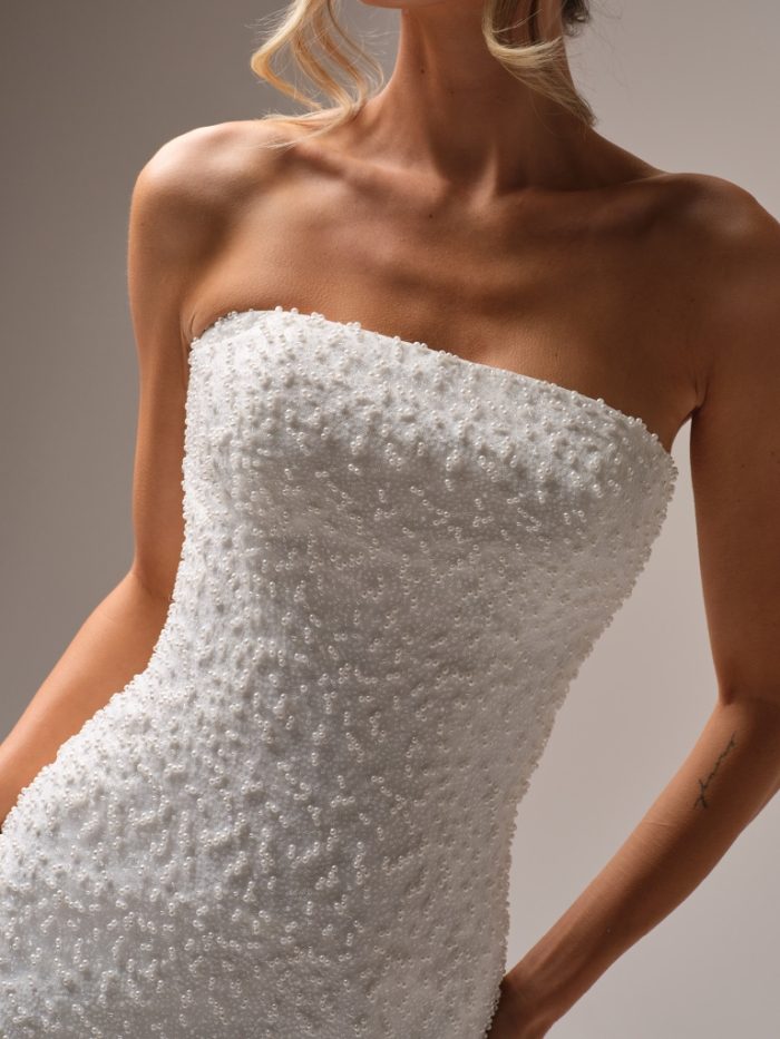 Close-up of Rebecca Ingram Taylor short wedding dress featuring a strapless neckline and allover pearl beading.