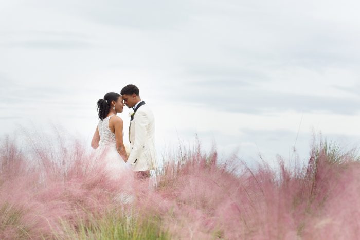 Bride wearing Lisette by Maggie Sottero and Groom in a grass field