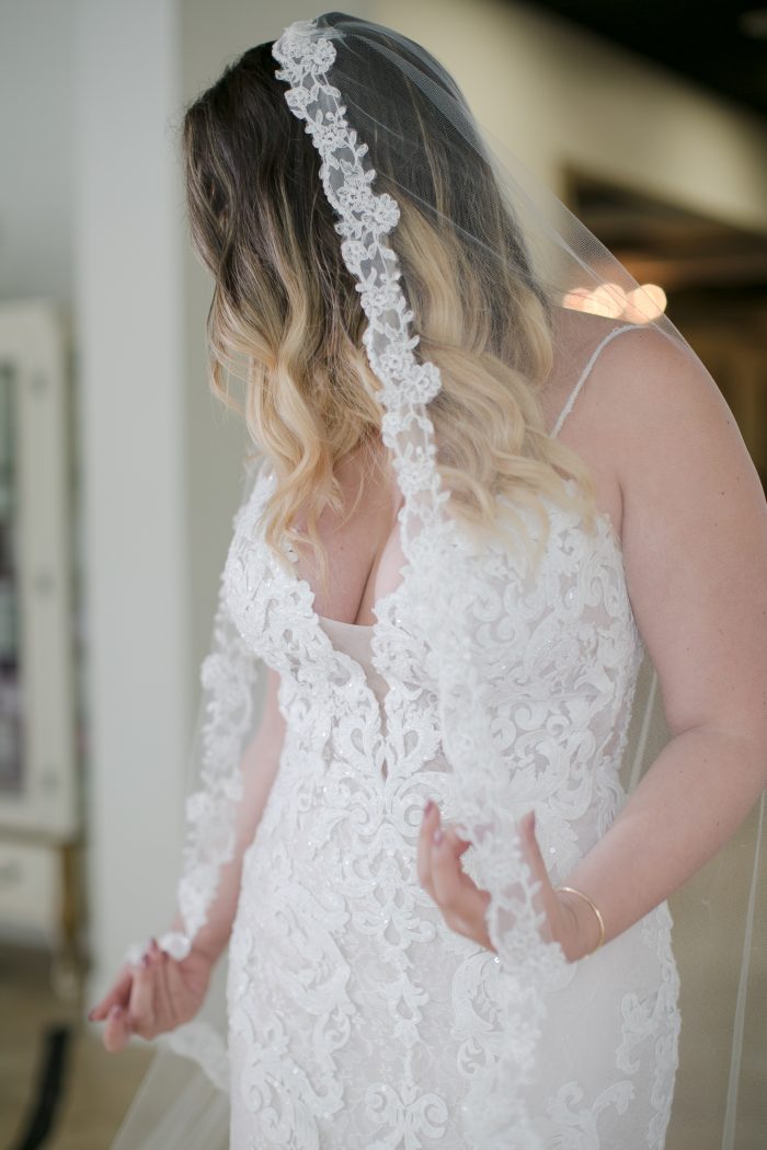 Bride Trying on Maggie Sottero Wedding Dress at a Store Event