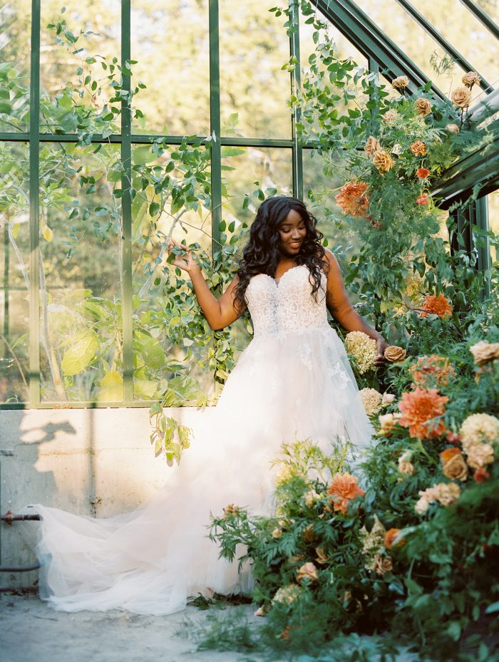 Bride in Greenhouse Wearing Lace Bodice Wedding Dress Called Marisol by Rebecca Ingram
