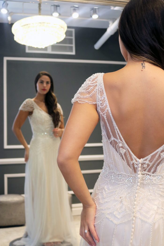 Real bride influencer trying on vintage wedding dress called Ettia by Maggie Sottero