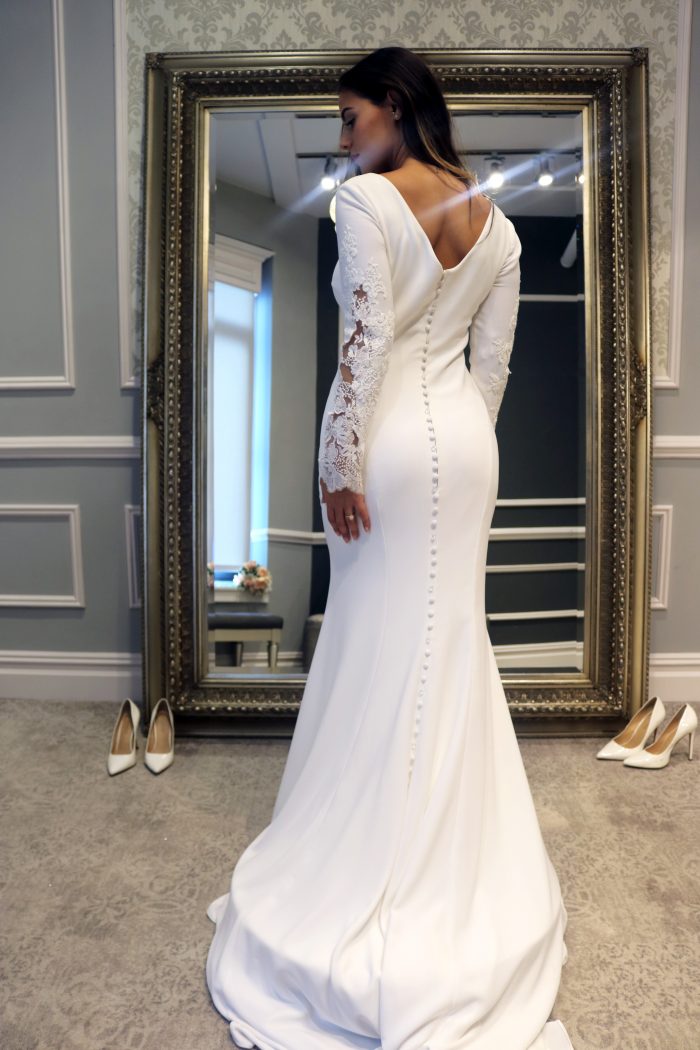 Real bride influencer wearing modest sheath wedding dress called Olyssia by Maggie Sottero