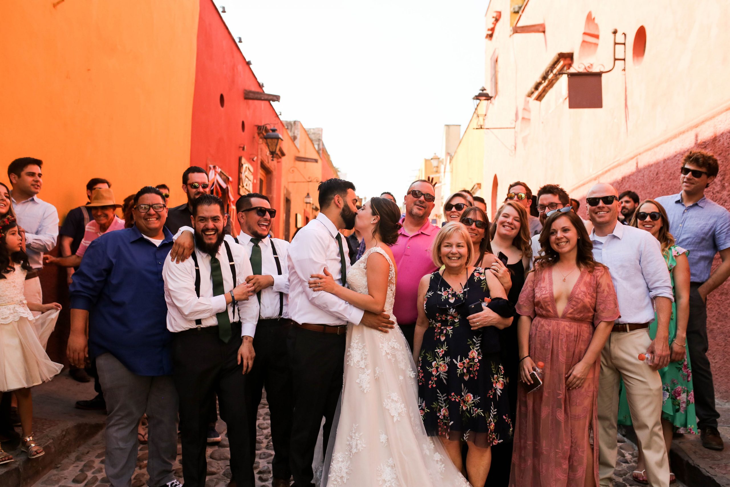 Groom Kissing Real Bride in Front of Wedding Party at Multicultural Wedding