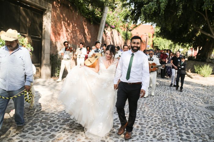 Real Bride and Groom Walking Down the Streets of San Miguel de Allende for Traditional Callejoneada