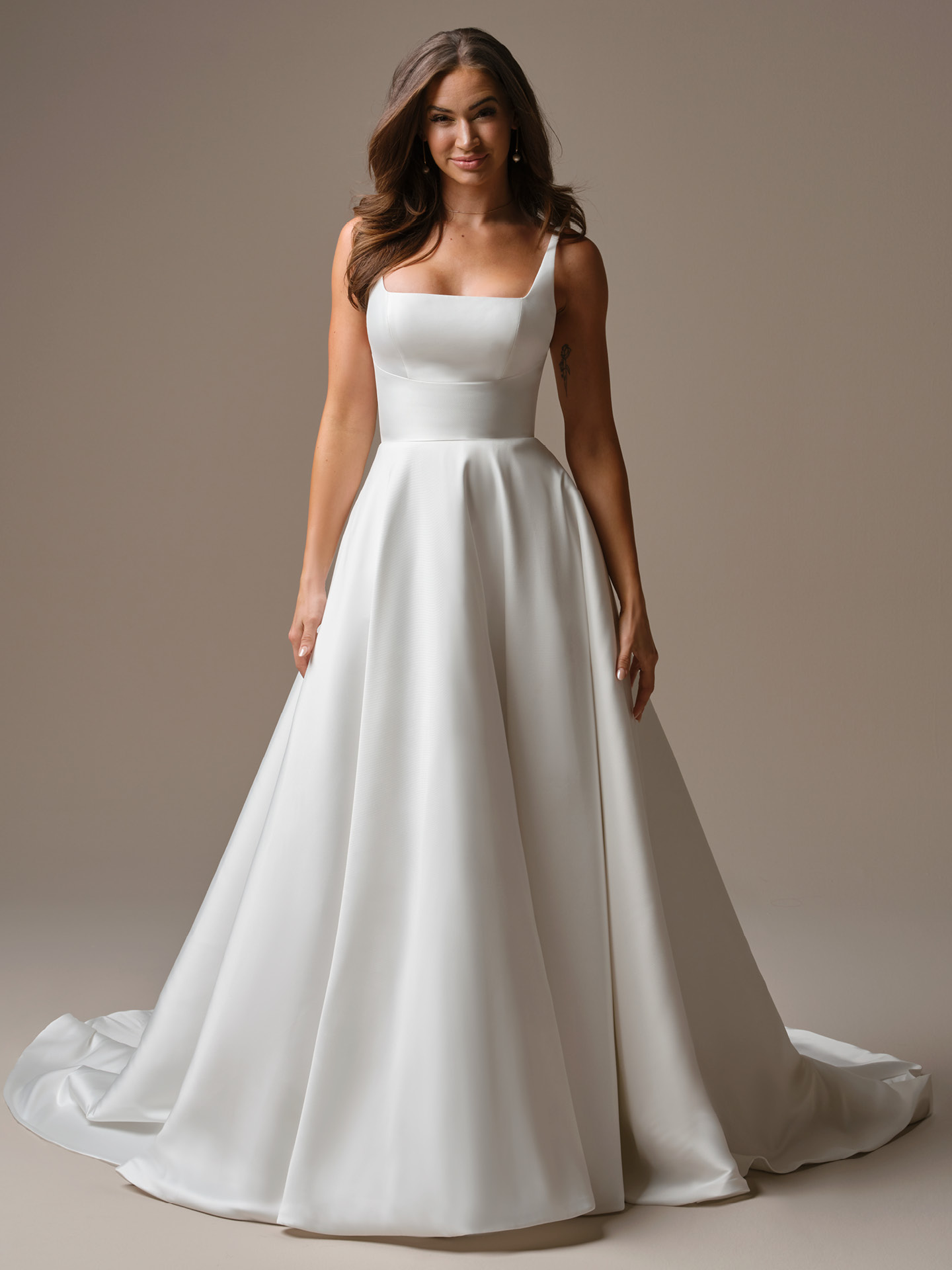 Galina A-line wedding dress featuring a square neckline with wide straps, clean satin bodice, and a full skirt for a timeless, minimalist bridal silhouette