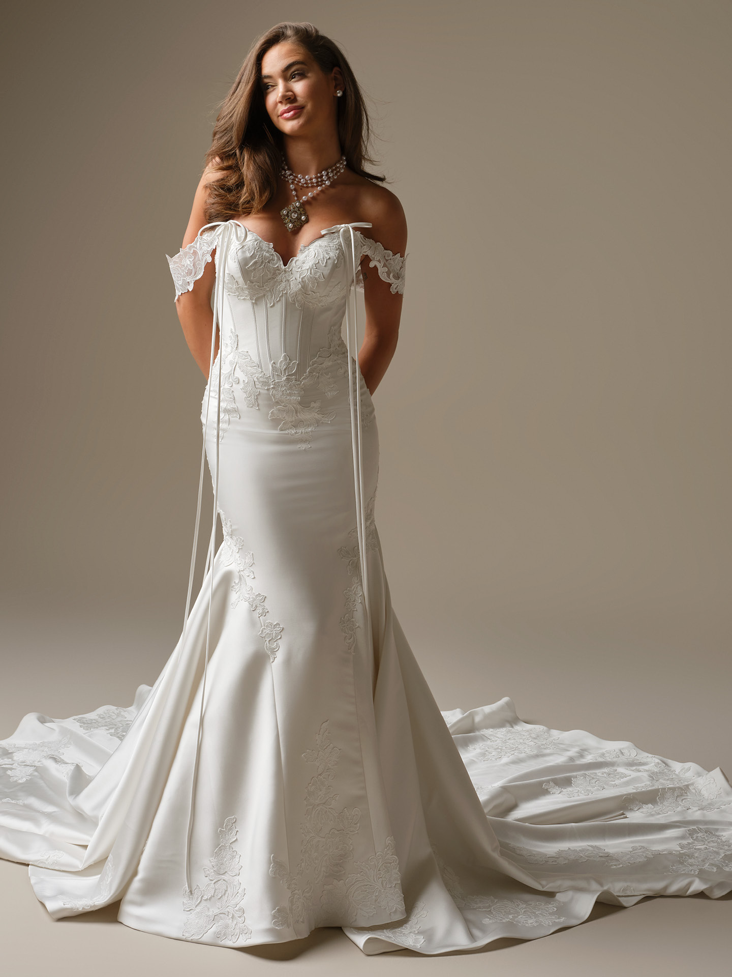 Serafina Lane fit-and-flare wedding dress featuring an off-the-shoulder sweetheart neckline with lace straps, structured corset bodice, and fitted silhouette with a soft train