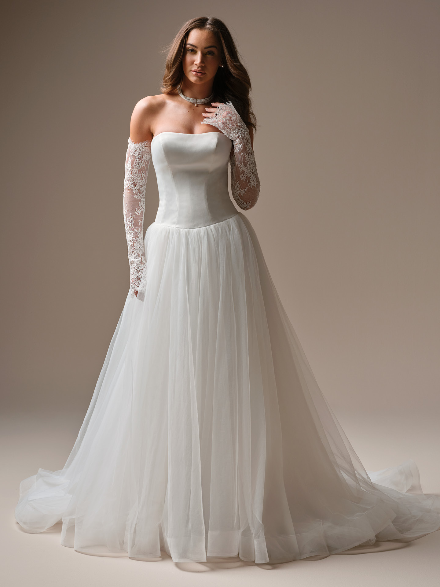 Shirley ballgown wedding dress featuring a strapless straight neckline, structured satin bodice, and soft tulle skirt with off-the-shoulder lace sleeves for a romantic, airy finish