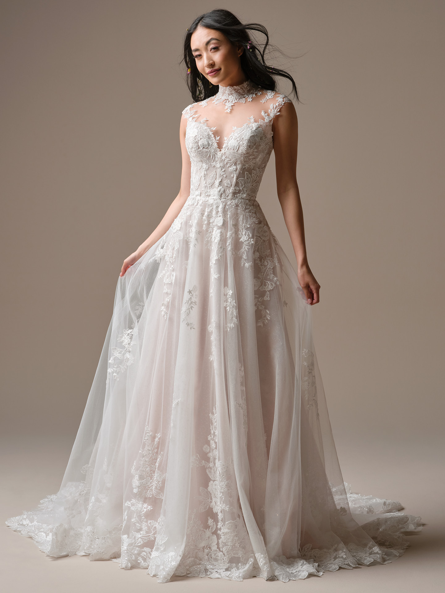 Cody A-line wedding dress featuring an illusion high neckline, sleeveless bodice with floral lace appliqué, and a soft tulle skirt with scattered lace detailing