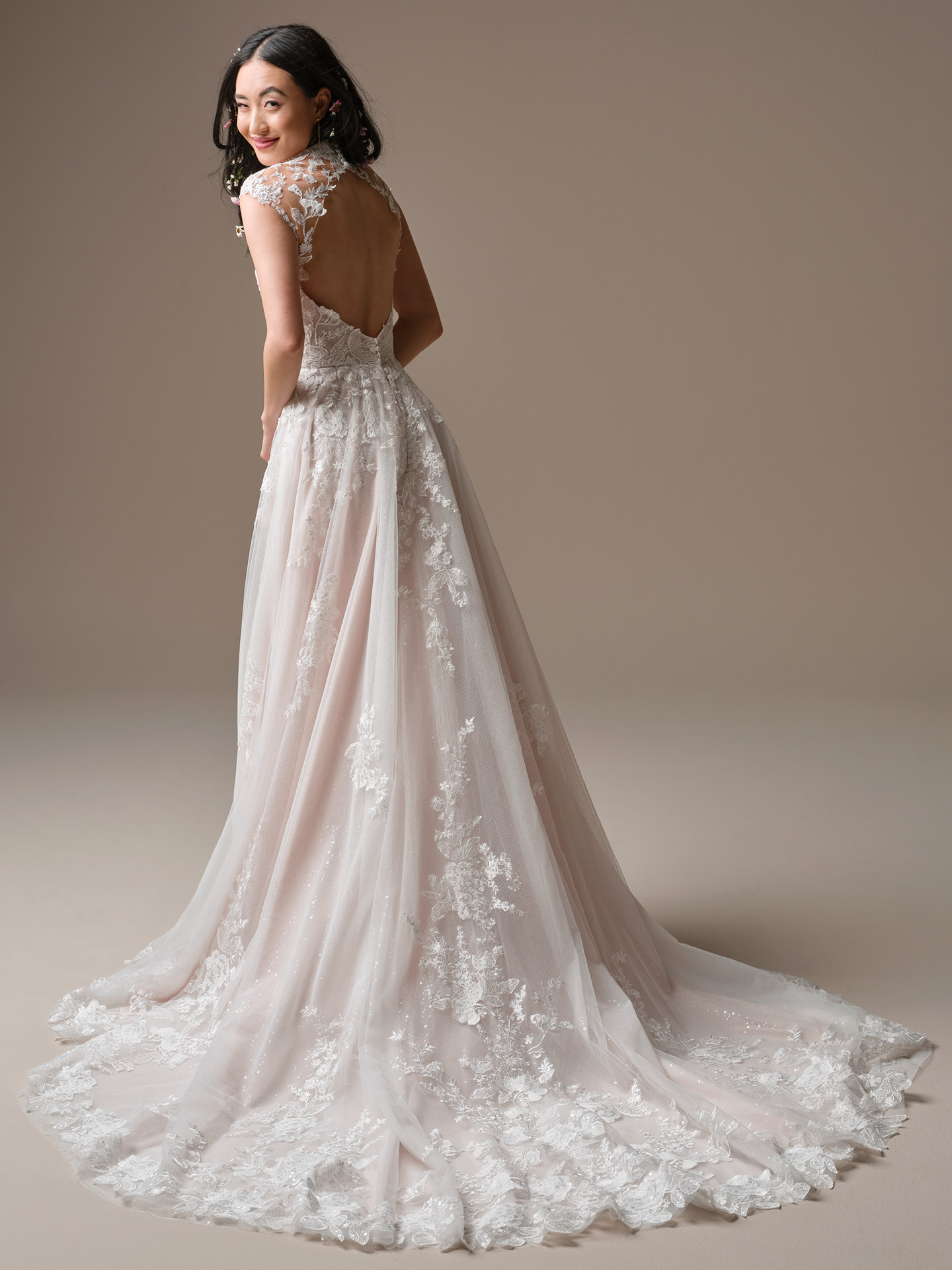 Cody A-line wedding dress back view with an illusion lace neckline, open keyhole back, and flowing tulle skirt finished with delicate lace appliqué and a sweeping train