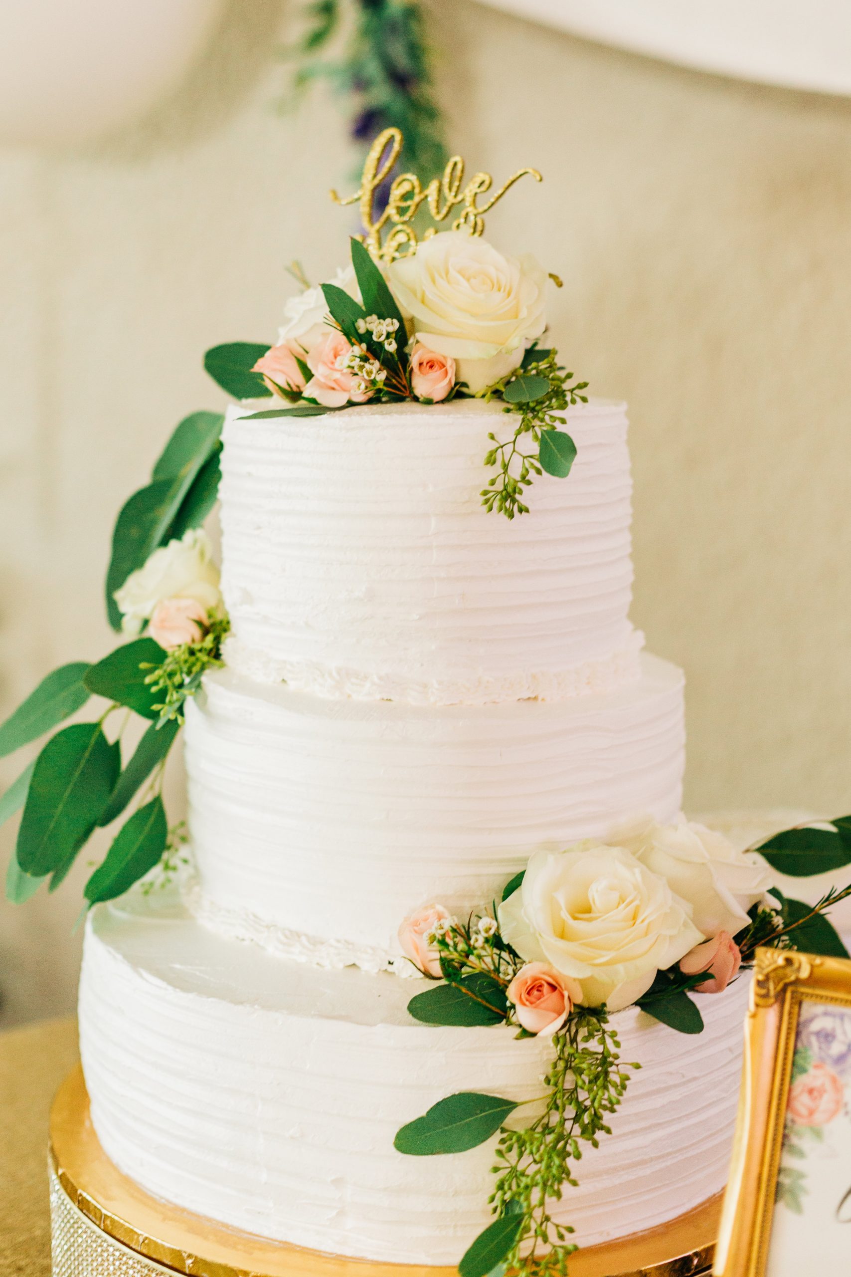 White Wedding Cake with Green and Pink Flowers for Spring Wedding