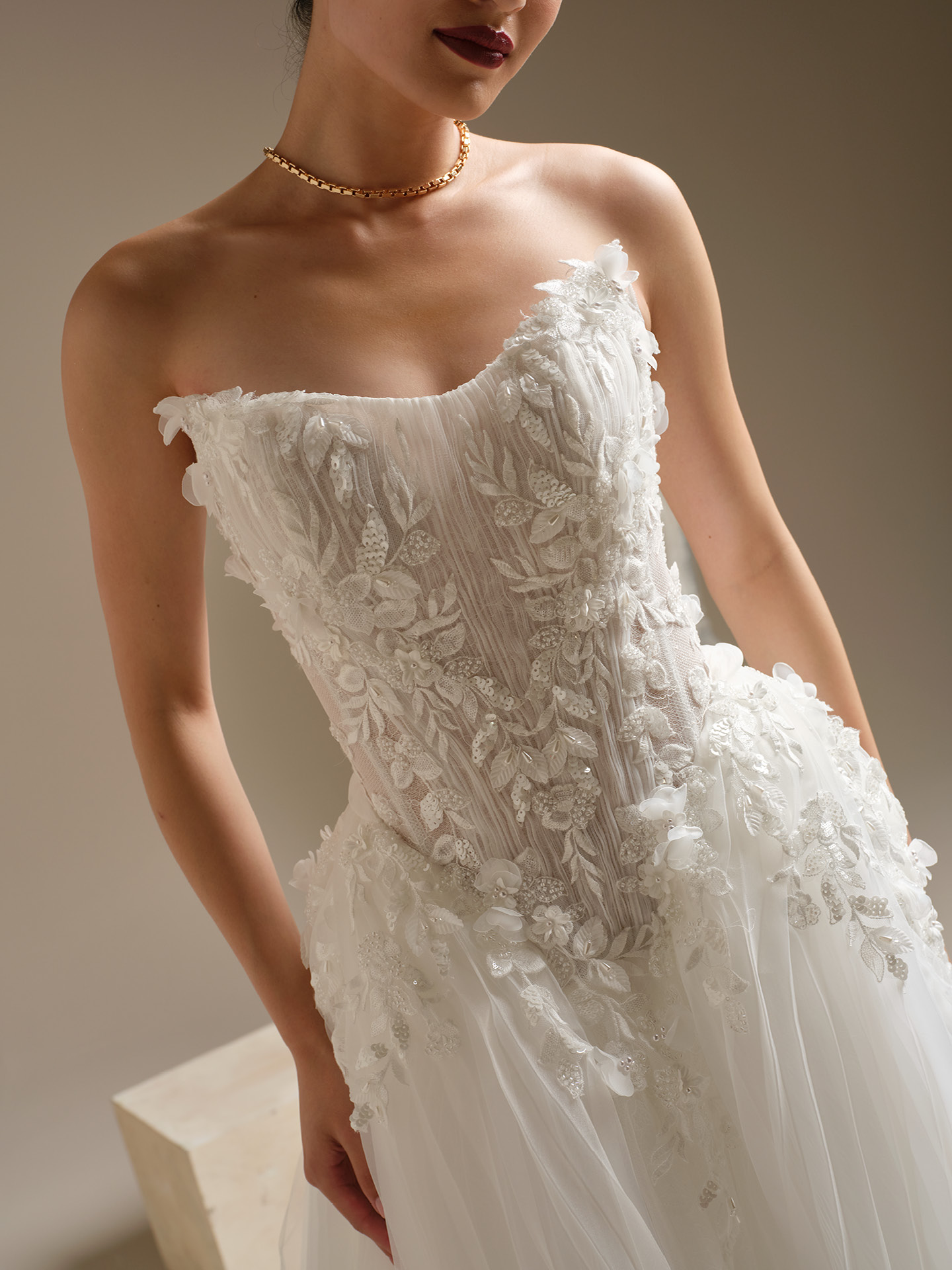 Jayna ballgown wedding dress close-up of strapless sweetheart bodice with intricate floral lace appliqués, pleated detailing, and soft illusion structure