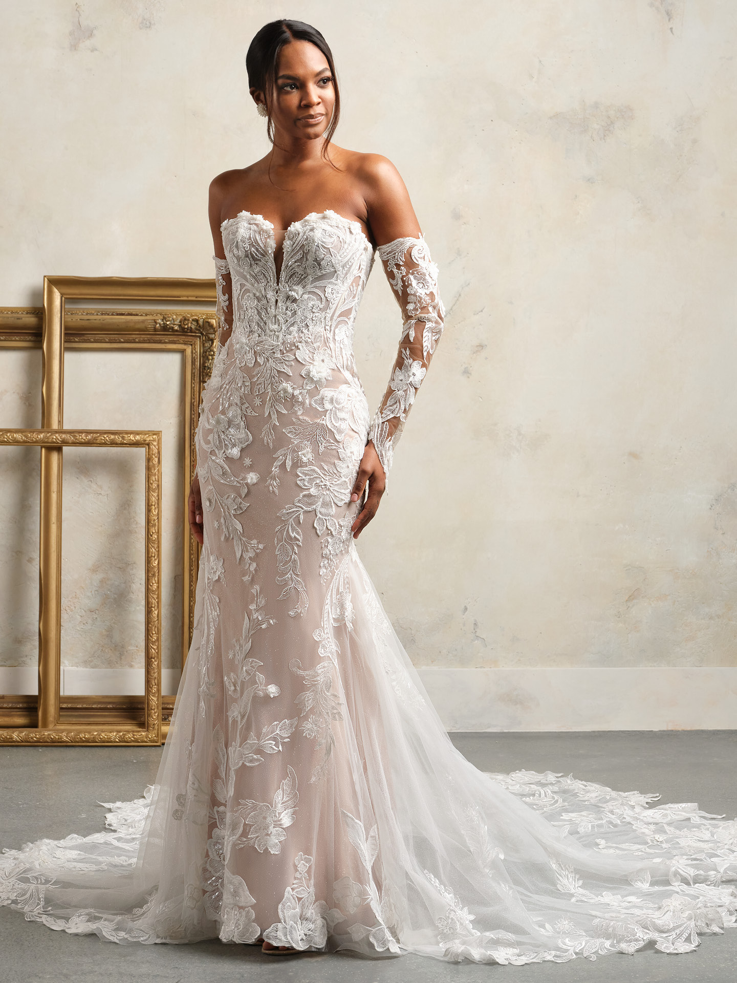 Nyjah fit-and-flare wedding dress featuring a strapless plunging sweetheart neckline, sheer corset bodice, and intricate 3D floral lace over a fitted silhouette with a soft illusion train