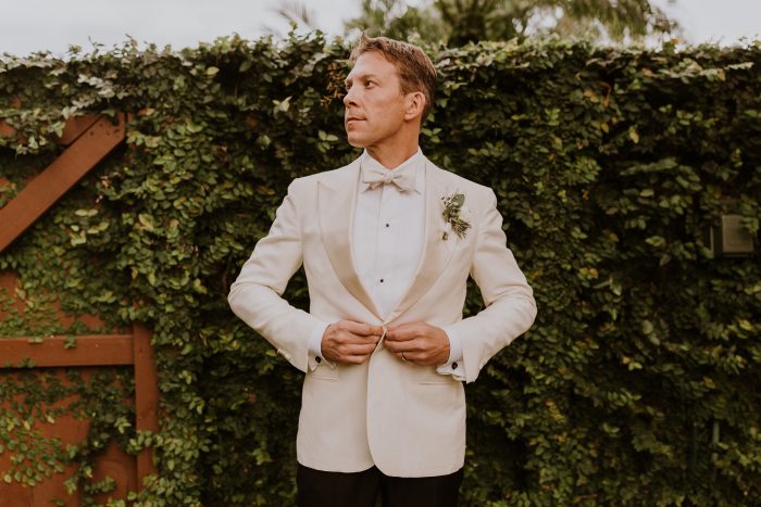 Real Groom Wearing White Suit and Bow Tie With Black Suit Pants