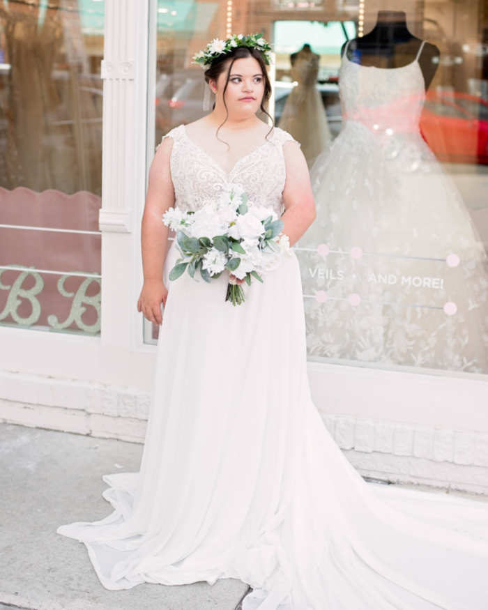 Bride trying on wedding dresses by Maggie Sottero at a bridal boutique