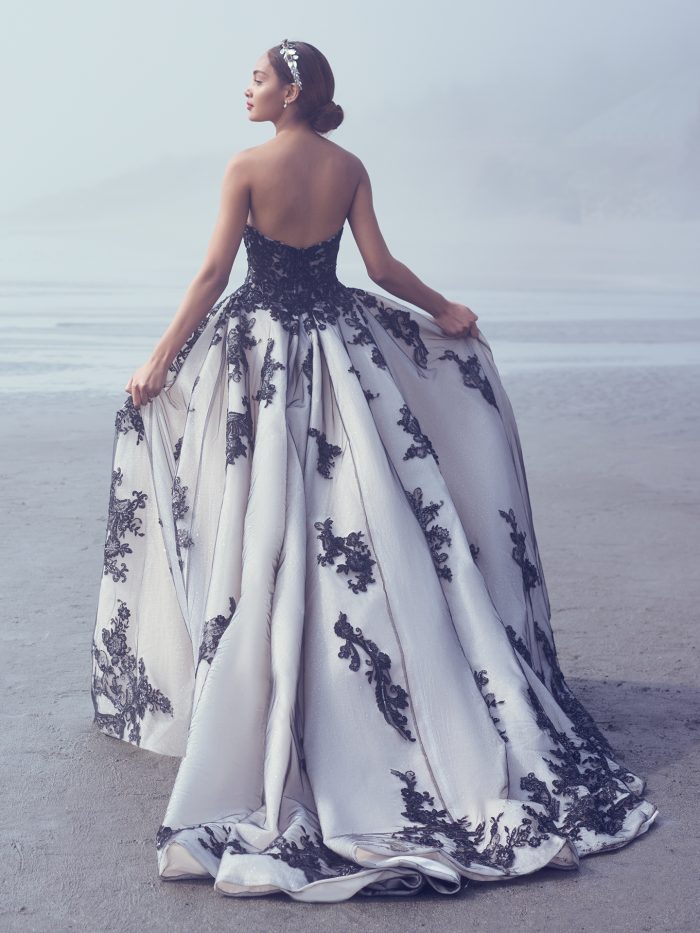 Bride Walking On Beach Wearing Glamorous Ball Gown Wedding Dress Called Norvinia by Sottero and Midgley