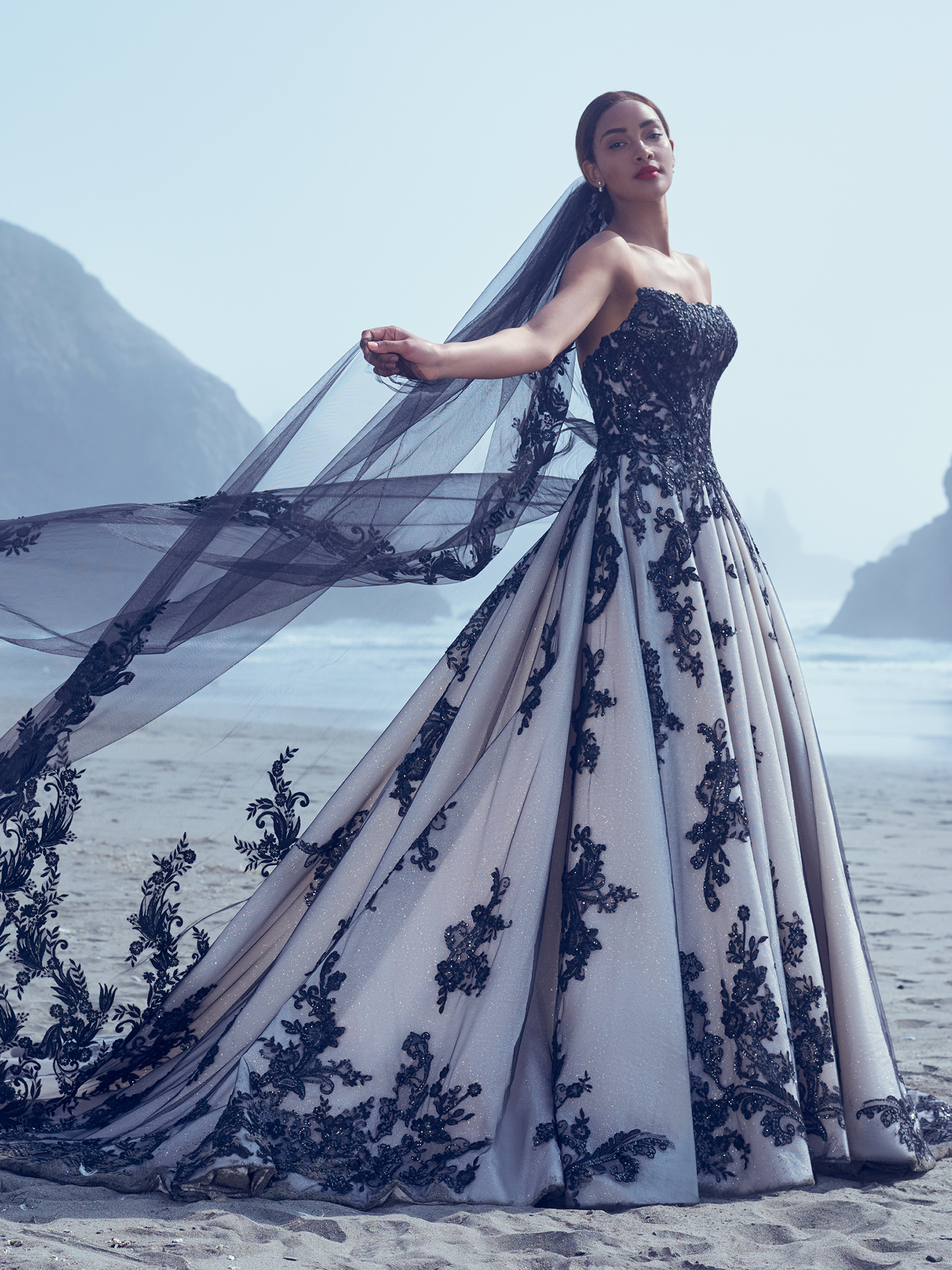 Mariée sur la plage portant une robe de mariée glamour appelée Norvinia par Sottero et Midgley
