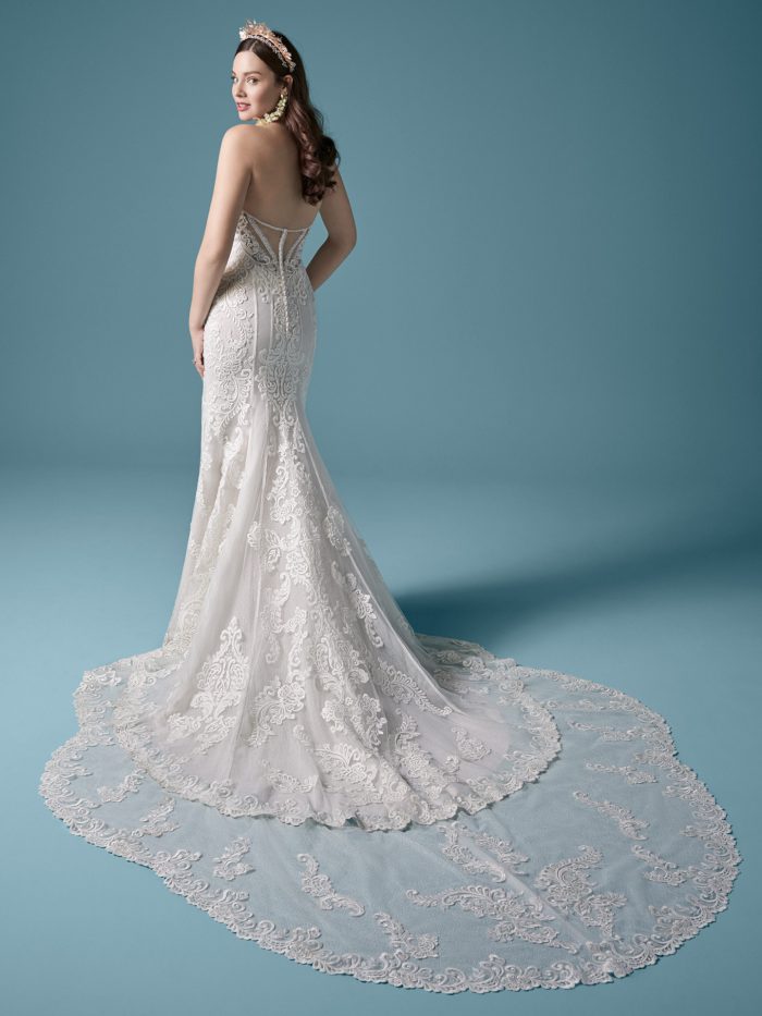 Model Wearing Long Train Elegant Lace Sheath Wedding Gown Called Erin Marie by Maggie Sottero