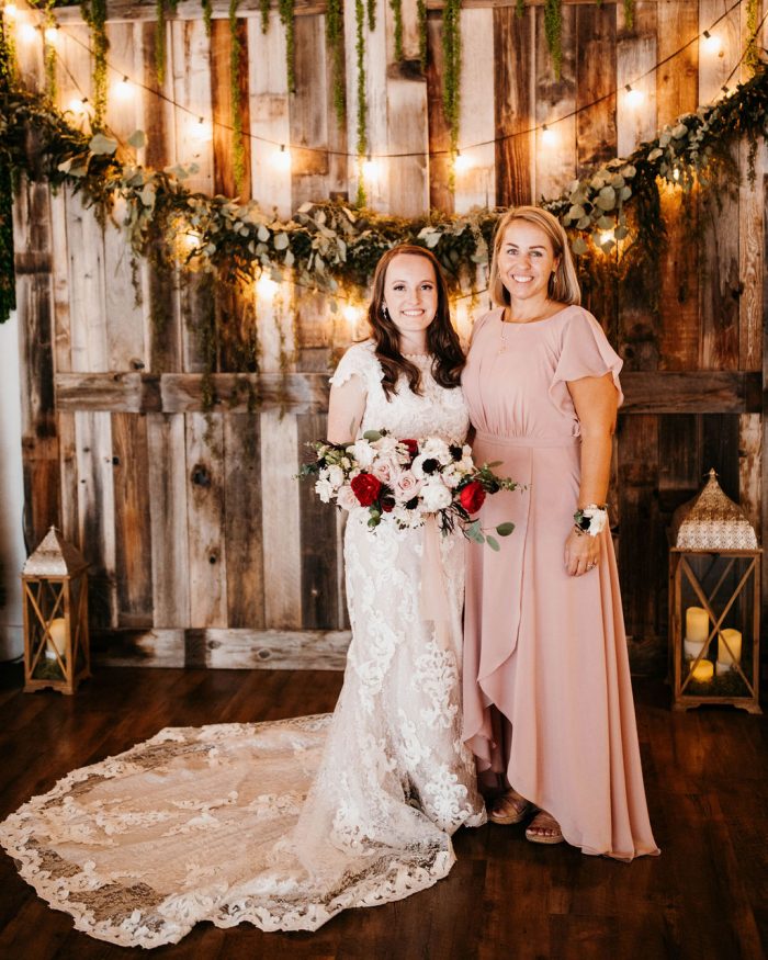 Mother of Bride Wearing a Blush Modest Mother of the Bride Dress Standing with Bride