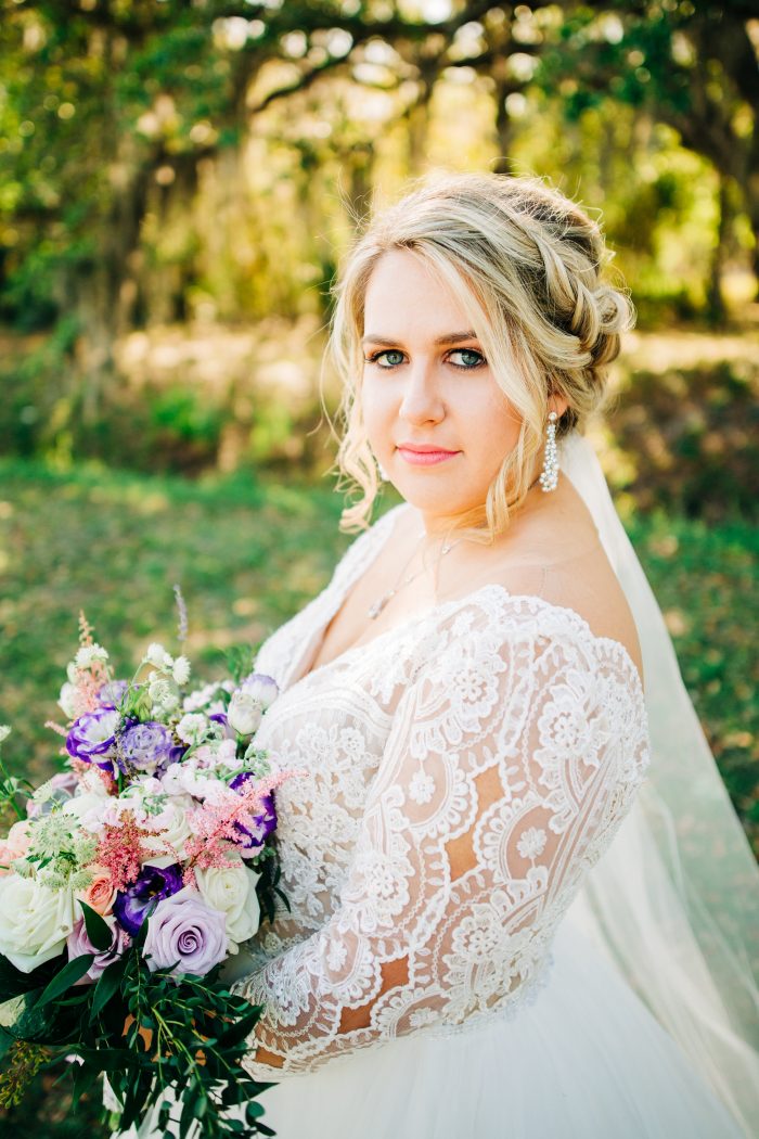 Real Curvy Bride Holding Colorful Bouquet and Wearing Illusion Lace Ball Gown Wedding Dress Called Mallory Dawn by Maggie Sottero