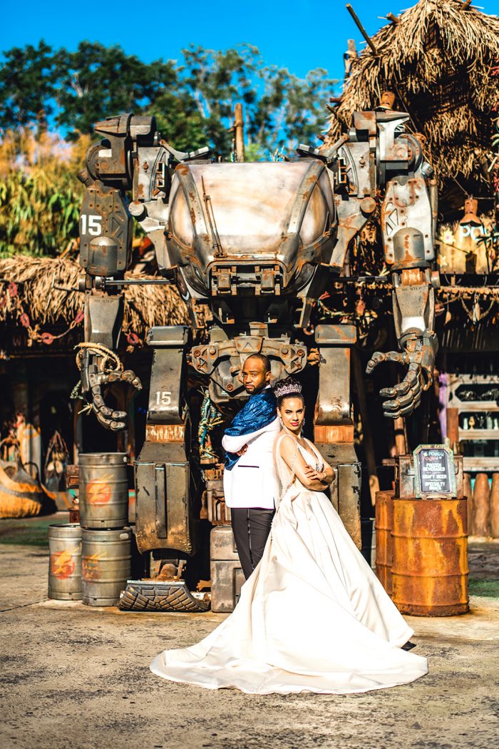 Groom Posing with Real Bride Wearing Princess Wedding Dress in Front of Star Wars Ride in Disney World