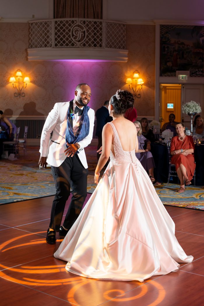 Groom Dancing with Real Bride Wearing Satin Ball Gown Wedding Dress Mylene by Maggie Sottero