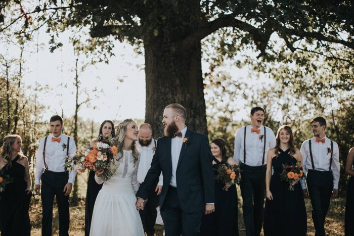 Bride and Groom Standing in Front of Wedding Party at Outdoor Boho Wedding