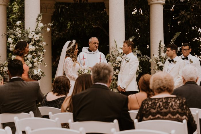 Groom with Real Bride and Officiant Social Distancing with Guests During Covid Wedding