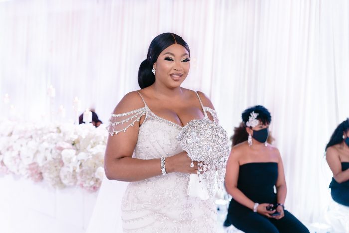 Black Bride Walking Down the Aisle and Wearing a Plus Size Maggie Sottero Wedding Dress