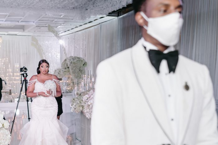 Real Bride Walking Down the Aisle at Socially Distanced Wedding While Groom Wears a Mask