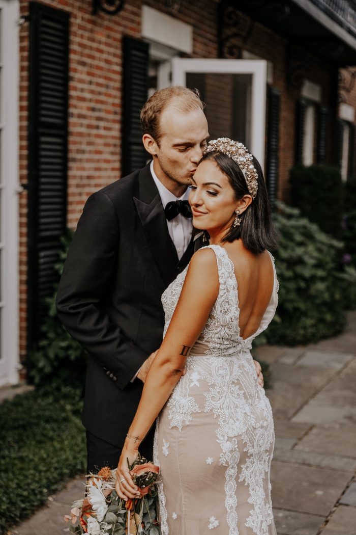 Groom Kissing Bride Wearing V-back Sheath Wedding Dress Called Agata Louise by Sottero and Midgley