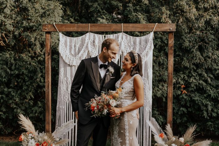 Groom with Real Bride Under Arbor for Backyard Elopement Ceremony