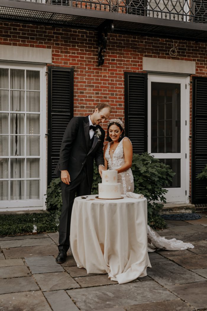 Groom with Real Bride Cutting Wedding Cake at Backyard Elopement