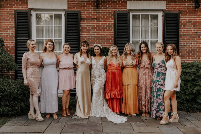 Real Bride Wearing Boho Wedding Dress Surrounded by Bridesmaids Wearing Mismatching Dresses