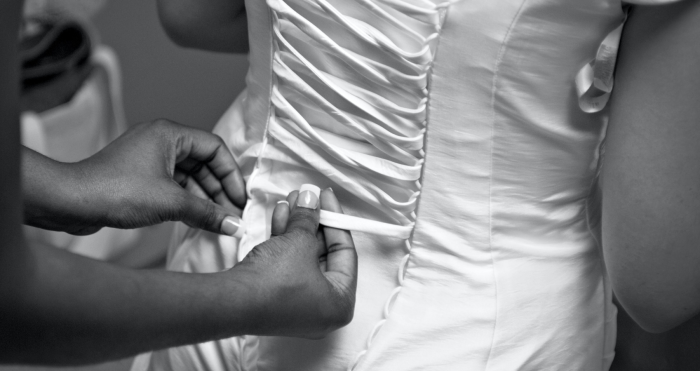 Wedding Undergarments Photo In Black And White Of A Bride Having Her Corset Done On Her Wedding Day