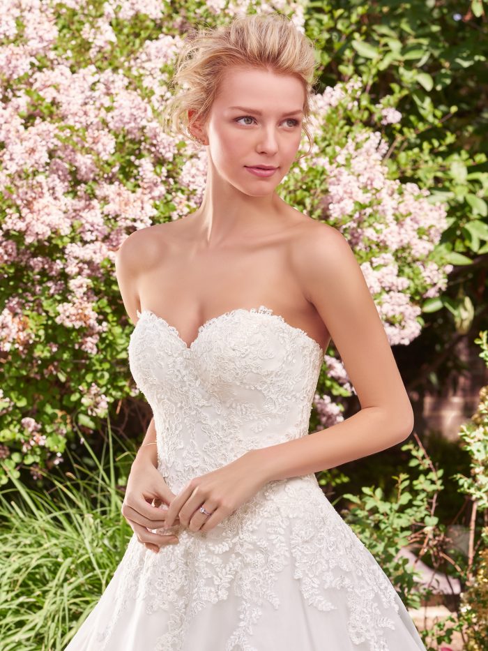 Model Wearing Strapless Lace Tea Length Wedding Dress Called Darlene Lane by Rebecca Ingram