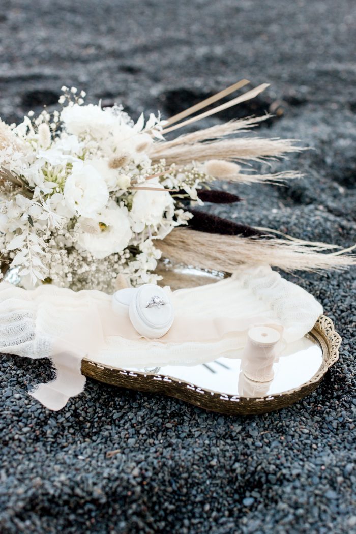 White Wedding Bouquet and Ring on Black Sand Beach