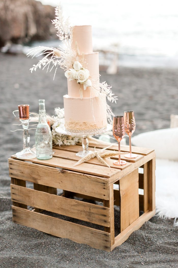 Three Tiered Wedding Cake on Driftwood Bin on Black Sand Beach