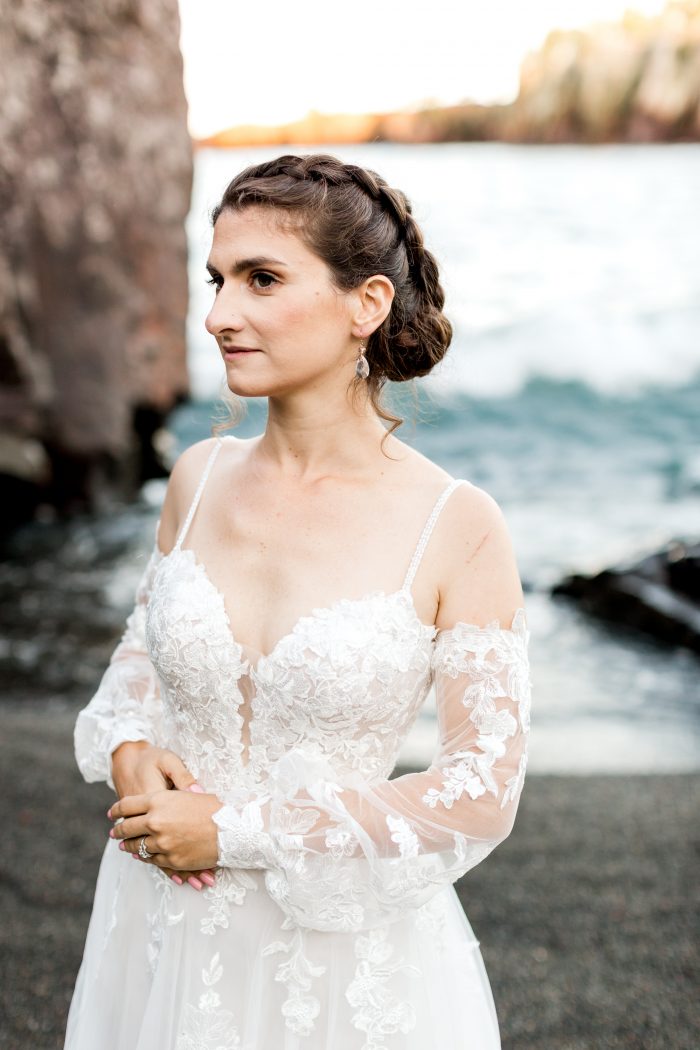 Real Bride on Black Beach Wearing Sleeved Floral Wedding Dress Called Stevie by Maggie Sottero